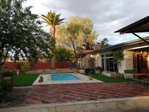 a backyard with a swimming pool and a house at Okahandja Guesthouse in Okahandja +17 photos