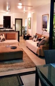 a living room with two couches and a table at Beach Apartment - Trou aux Biches - Ground Floor in Mont Choisy