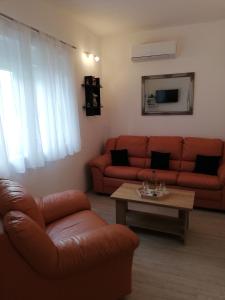 a living room with a couch and a table at APARTMANI NOVA in Živogošće