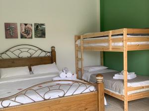 A bed or beds in a room at Anastasios Olive Garden Apartments