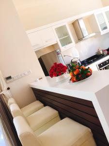 a kitchen with a counter with flowers on it at LuxSea Villa in Phan Thiet