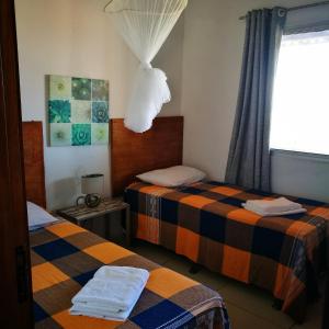 Łóżko lub łóżka w pokoju w obiekcie Natal Casa de Playa Coqueiros