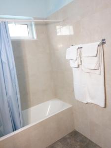 a bathroom with a bath tub and towels at Kriti Studios in Agia Galini