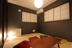 a living room with a table and some pillows at Fuji Time traveler 新館 in Fujikawaguchiko
