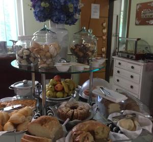 a table filled with different types of bread and pastries at Aruanã Palace Hotel in Colíder