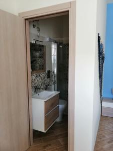 a bathroom with a sink and a toilet and a mirror at B&B Stella del Mare in Lampedusa