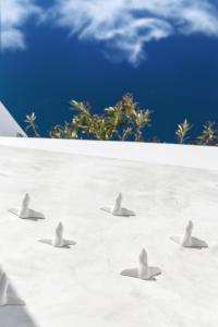 four birds flying in the sky on a beach at Saluti Da Stampalia in Astypalaia Town