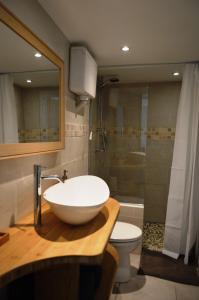 a bathroom with a white sink and a toilet at Charmante maisonnette indépendante à Goult en Luberon in Goult +23 photos