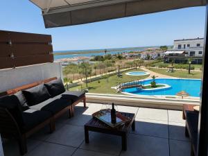 a living room with a view of a pool at ARCA DE BUEY LA RESERVA in El Rompido