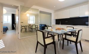una cucina e una sala da pranzo con tavolo e sedie di RMH Lopud Lafodia Resort & Wellness a Lopud