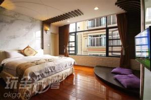 a bedroom with a bed and a large window at Shuian Lakeside Hotel in Yuchi