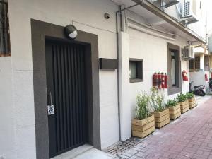 a black door on the side of a building at In.T in Tainan