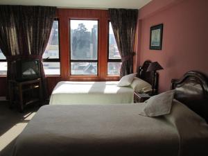 Postel nebo postele na pokoji v ubytování Hotel Apart Colón