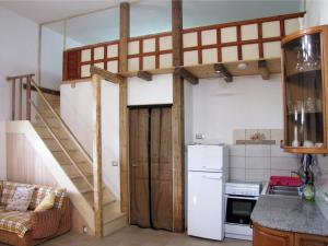 a loft bed in a kitchen with a staircase at Terreno Ro-Bi-Li Ferienwohnung in Cutrofiano