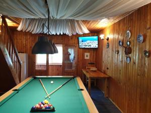 a room with a pool table and a tv at Vila Lucica in Sinaia