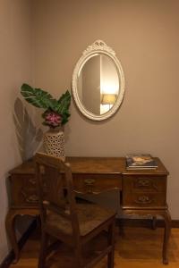 a wooden dresser with a mirror on top of it at Being Porto Hostel in Porto