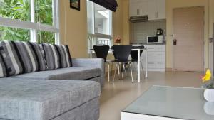 a living room with a couch and a kitchen at The Sea Condominium 267/50 in Sam Roi Yot