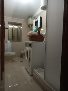 a bathroom with a washer and dryer in it at Casa Giordano Holidays in Tramonti