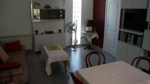 a living room with a couch and a table at Clos l'Oustal in Labastide-de-Virac