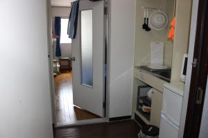 a hallway with a door leading into a kitchen at マンションロアジス 大阪市東淀川区相川 in Osaka +48 photos