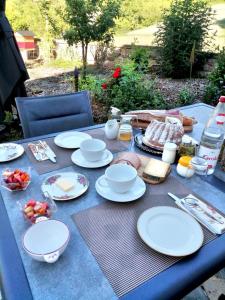 une table bleue avec des plaques blanches et de la nourriture dans l'établissement Aux vignes, à Wissembourg