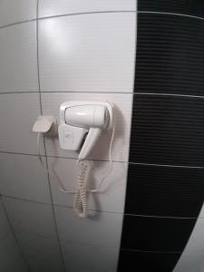 a phone hanging on a wall in a bathroom at Apartment Jonoski in Ohrid