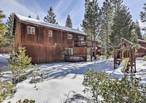 a wooden barn in the snow with a playground at Kingswood Estate Cabin Retreat in Kings Beach