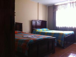 Postel nebo postele na pokoji v ubytování Hostal Jora Continental