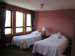 Postel nebo postele na pokoji v ubytování Hotel Apart Colón