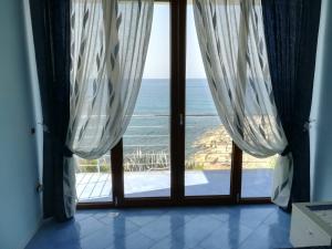 a room with a view of the ocean through a door at Casa Notaro Sorrentino in Acciaroli