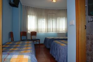 Posteľ alebo postele v izbe v ubytovaní Hostal Campus