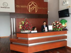 two women standing at a reception desk in a lobby at Nakhone Champa Hotel in Pakse