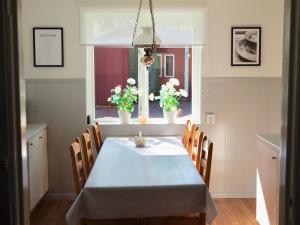 a dining room with a table and chairs and a window at Orsastuguthyrning-Born in Orsa