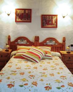 a bedroom with a bed with two pillows on it at Hotel Rural Bentor in Los Realejos