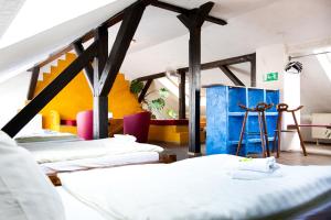 a group of beds in a room with yellow walls at Gästehaus Mezcalero in Dresden