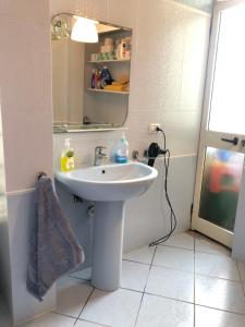a bathroom with a sink and a mirror at Beach View! Seaside Apartment in Durrës