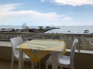 a table and chairs with a view of the beach at Beach View! Seaside Apartment in Durrës