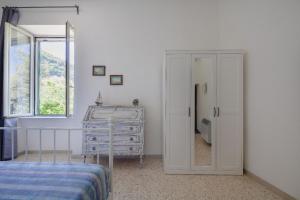 a bedroom with a bed and a dresser at Villa Beatrice in Sorrento