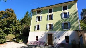 a large green and white building with a door at Camping White Rock in Castellane