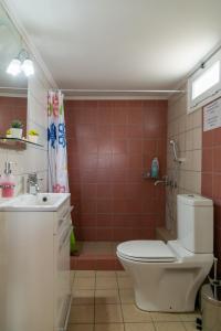 a bathroom with a toilet and a sink at Rose's House (Near Airport) in Artemida