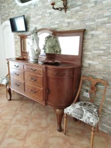 a dresser with a mirror and two horse heads on it at The Roses Garden in La Maddalena