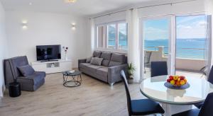 a living room with a couch and a table at Apartmani Ticinovic in Omiš