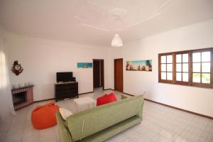 a living room with a couch and a television at White Bride FZ in Fuzeta
