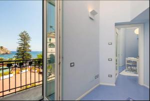 a room with a balcony with a view of the ocean at Il Pennello in Amalfi