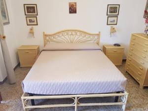 a bedroom with a bed with two night stands and two dressers at Villa del Golfo Urio with swimming pool shared by the two apartments it is essential to have a car in Santa Flavia +88 photos
