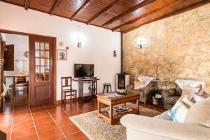 a living room with a couch and a table at Rustic Holiday House in the Natural Park in Alcobertas