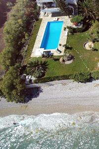 an aerial view of a swimming pool on a beach at Antorina Beachfront Villas in Kamárion