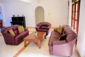 a living room with two couches and a coffee table at Homestay Garden Rest Kandy in Kandy