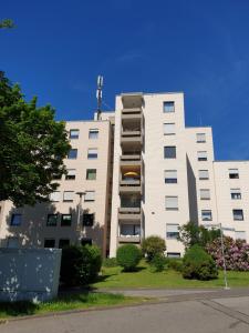 a large white building with a tree in front of it at 60 qm mit Aussicht in Konz in Konz