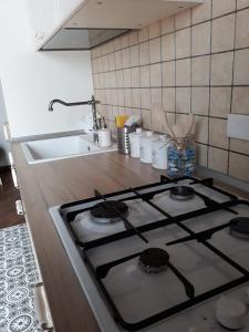 a stove top oven in a kitchen with a sink at Casa PAN (Percorso Arabo Normanno) in Palermo